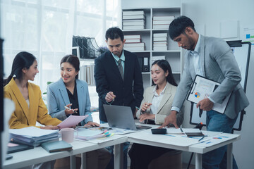 Collaborative Business Meeting: A team of professionals engaged in a productive discussion, analyzing data and collaborating on strategies in a modern office setting.  