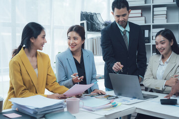 Business Team Collaboration: A diverse group of professionals engages in a productive discussion around a table, showcasing teamwork, collaboration, and communication in a modern office setting.  