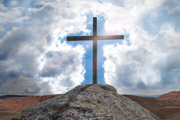 Wooden cross on a mountain against the sky. Biblical scene, concept of Holy Scriptures of Old and...