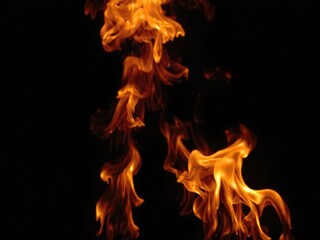 Fiery flames dancing against a dark background, abstract