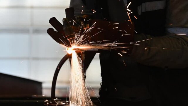 Factory worker cutting steel and metals with gas welding