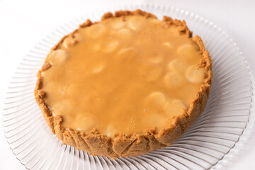 Banoffee banana pie with caramel sauce on the white background. Traditional english cake. Ready to eat. Cooking concept