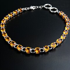 Polished silver chain with citrine stones warm and sunny on plain black dark background