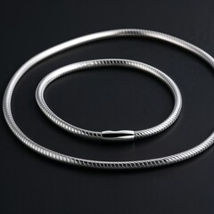 Rhodium plated silver snake chain sleek and shiny on plain black dark background