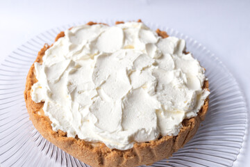Banoffee banana pie with caramel sauce and cheese cream on the white background. Traditional english cake. Ready to eat. Cooking concept