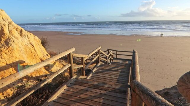 Walkway with wooden steps on Cuesta Maneli beach, located in a very unique environment, the fossil dune system of El Asperillo, located within the Do&ntilde;ana Natural Park , Huelva, Spain.
