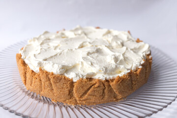 Banoffee banana pie with caramel sauce and cheese cream on the white background. Traditional english cake. Ready to eat. Cooking concept
