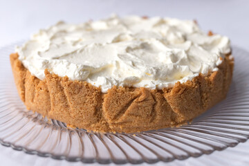 Banoffee banana pie with caramel sauce and cheese cream on the white background. Traditional english cake. Ready to eat. Cooking concept