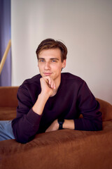 portrait of an attractive young 20 year old man with dark hair and blue eyes, studio photo shoot
