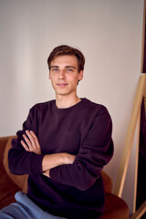 Fototapeta premium portrait of an attractive young 20 year old man with dark hair and blue eyes, studio photo shoot