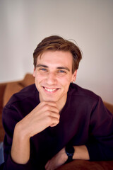 portrait of an attractive young 20 year old man with dark hair and blue eyes, studio photo shoot