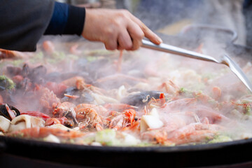 .Authentic seafood paella, made with fresh shrimp, mussels, squid, and tender fish, all simmered with saffron, garlic, bell peppers, tomatoes, and a touch of paprika.