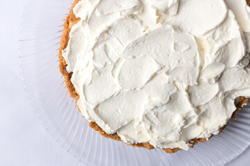 Banoffee banana pie with caramel sauce and cheese cream on the white background. Traditional english cake. Ready to eat. Cooking concept