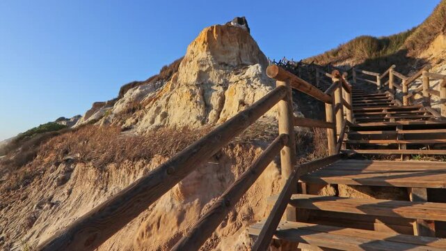 Walkway with wooden steps on Cuesta Maneli beach, located in a very unique environment, the fossil dune system of El Asperillo, located within the Do&ntilde;ana Natural Park , Huelva, Spain.