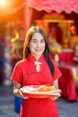 Woman in Red Dress Holding Fruits on a Plate