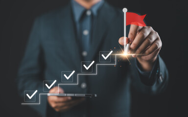 Business success and goal achievement steps. Businessman drawing checkmarks on virtual staircase steps toward achieving goals, ending with red flag as success marker. Planning, progress, goal setting,