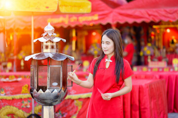 Woman in Red Dress with Lantern at Festival Celebration