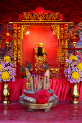 Vibrant Shrine with Golden Idol and Colorful Decorations