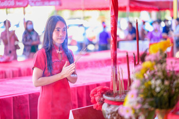 Young Woman Praying at Festive Temple Ceremony