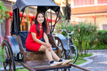 Young Woman in Red Dress Sitting on a Rickshaw
