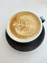 Latte art in a glass on a white background