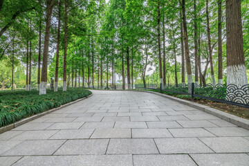 Fototapeta premium Empty brick floor and woods landscape in the park
