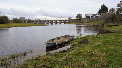 Old wooden fishing boat in river Shannon at Shannonbridge, Offaly, Ireland, nature background