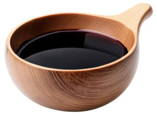 A small wooden bowl filled with dark soy sauce.