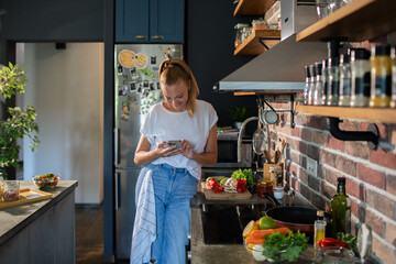 Young woman cooking healthy vegetables in modern kitchen