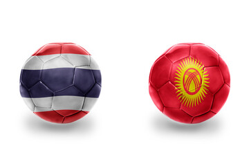 football balls with national flags of kyrgyzstan and thailand , soccer teams. on the white background.