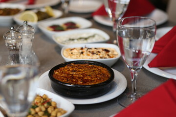 A traditional Turkish meze spread, featuring a variety of delicious and colorful dishes. The table is set with fresh bread, olives, and a variety of dips