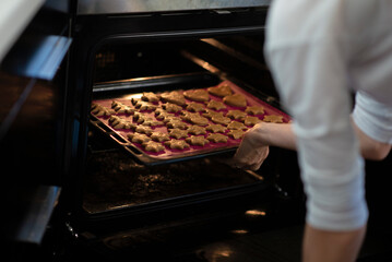  Placing freshly cut cookies in the oven