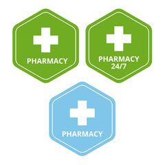 Green and light blue pharmacy signs with a white cross on a white background