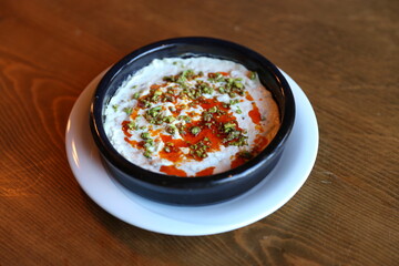 Creamy Hummus with Olive Oil and Paprika, Traditional Middle Eastern Dip, Served in a Clay Bowl, Vegan Friendly, Healthy Snack