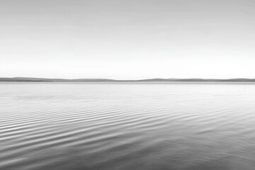 Calm water surface with gentle ripples, serene monochrome landscape.