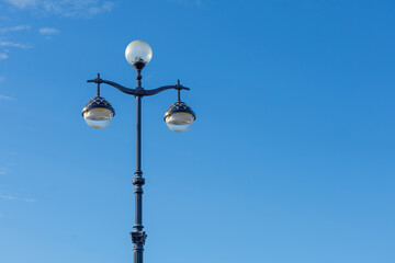 A beautiful city street light against a blue sky. Space for text.