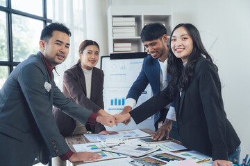 Business Team Fist Bump: A diverse group of professionals, united in their commitment to success, celebrate their collaboration and teamwork with a powerful fist bump.