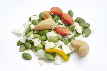 Assorted Nuts. lots of cashews, almonds, pumpkin seeds, coconut jam. Assorted nuts mix floating on white background. Fresh dry fruits isolated.