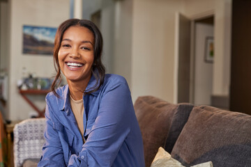 Cheerful beautiful mixed race woman smiling at home