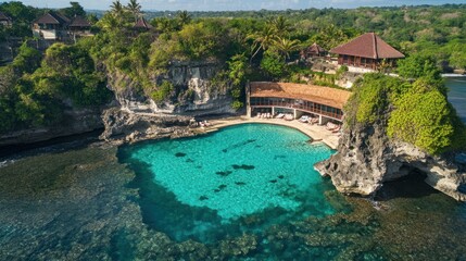 Fototapeta premium Aerial view of a serene coastal resort with clear turquoise waters and lush greenery.