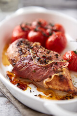 Baked chicken breasts with ham, cherry tomatoes. Close up. 