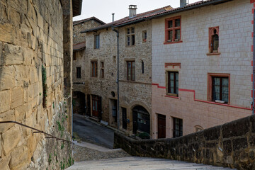 ST-ANTOINE-L'ABBAYE, FRANCE, November 5, 2024 : Main stairway and a street of the medieval village surrounding the Abbey of Saint-Antoine.