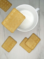 Cookies with cup of milk on wooden grey background
