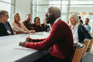 Confident businessman listening attentively in a meeting with colleagues