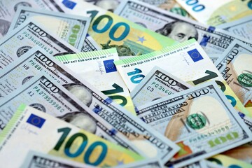 Obraz premium Big pile of Euro and USD banknotes. Many european and united states dollars