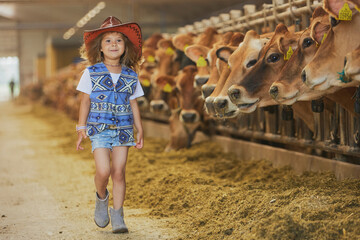 Charming child in a cowboy costume on a cows farm in Denmark