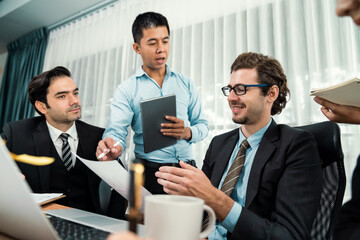 Diverse of business people from various ethnic group working in modern office environment. Productive and multi ethnic office workers engage in discussion for strategic business marketing. Habiliment