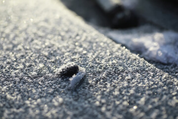 Close-Up Photograph of Frost on Asphalt Surface in Winter Morning Light