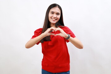 Young woman wearing casual red shirt smiling in love showing heart symbol and shape with hands. romantic concept.