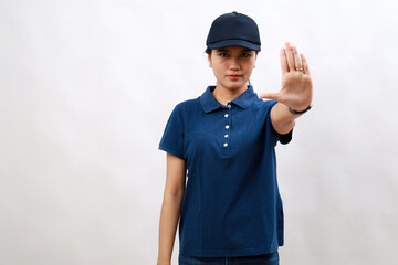 Young hispanic woman courier wearing delivery uniform and cap doing stop sing with palm of the hand. warning expression with negative and serious gesture on the face.